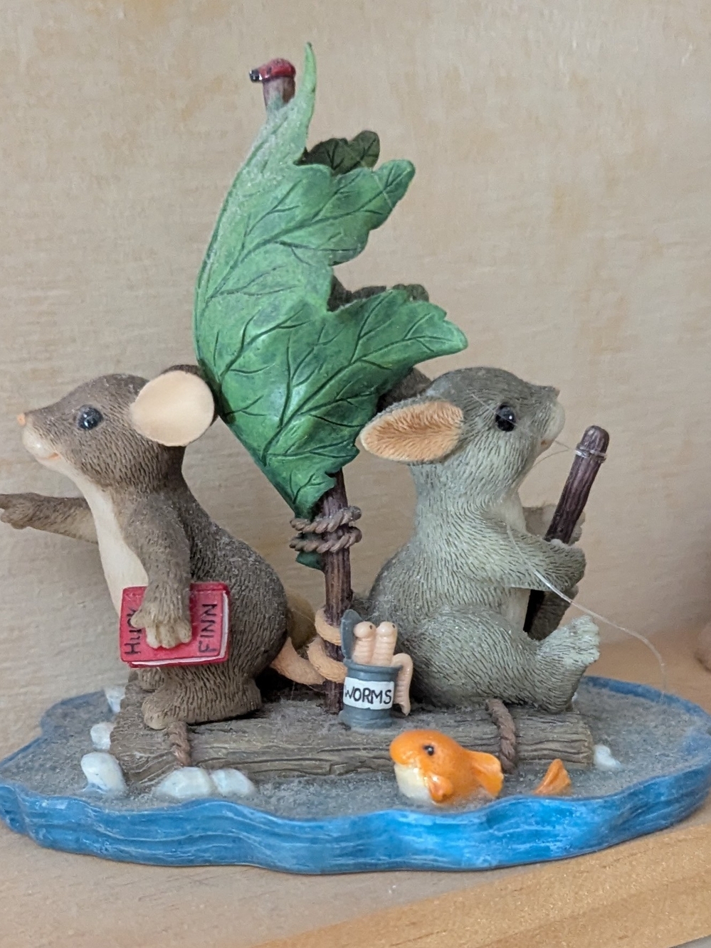 Whimsical Mouse Raft Figurine with Green Leaf Sail